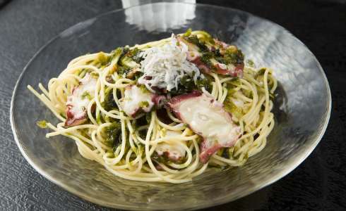 Cold spaghetti served with peperoncino, octopus and sea lettuce